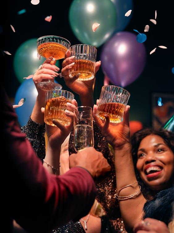 A group of people clinking glasses at a cocktail hour