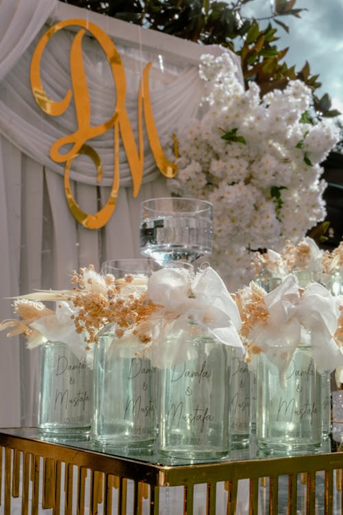 Monogrammed glass bottles set on a wedding table