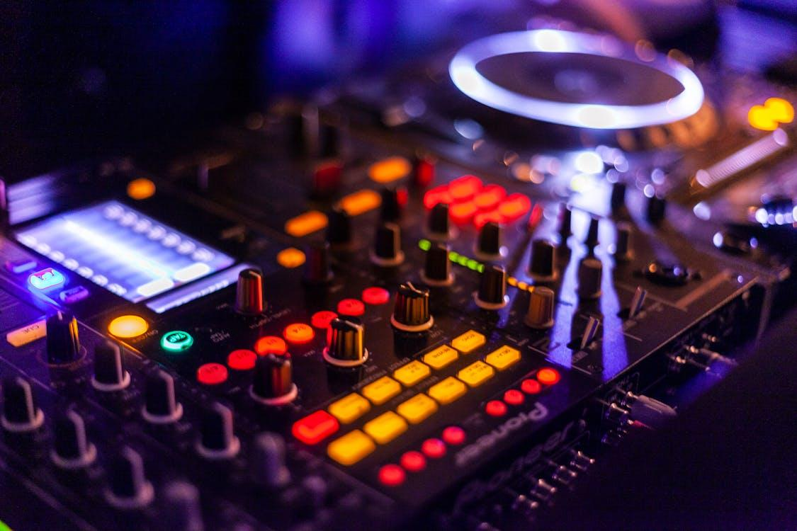 A close-up of a DJ controller glowing under wedding reception lights