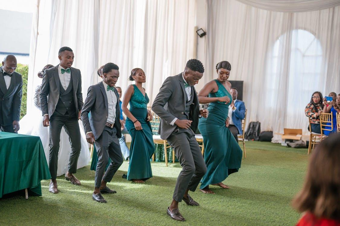 Wedding guests performing a choreographed dance on the grass