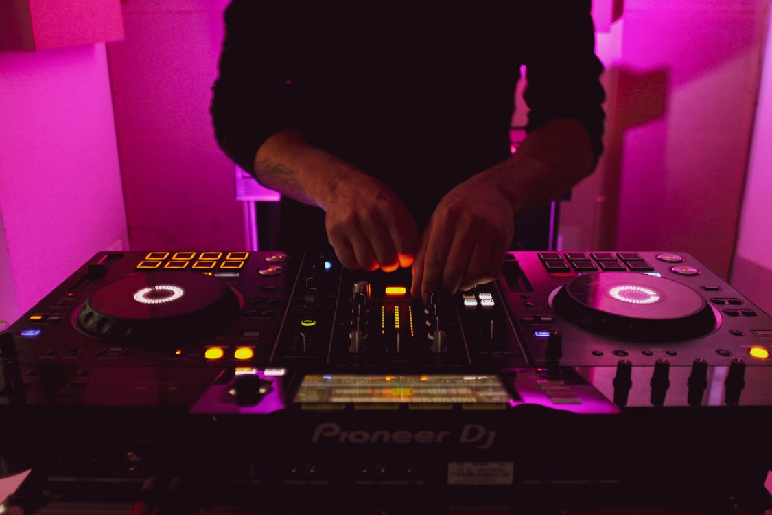 A man preparing a DJ playlist for an event