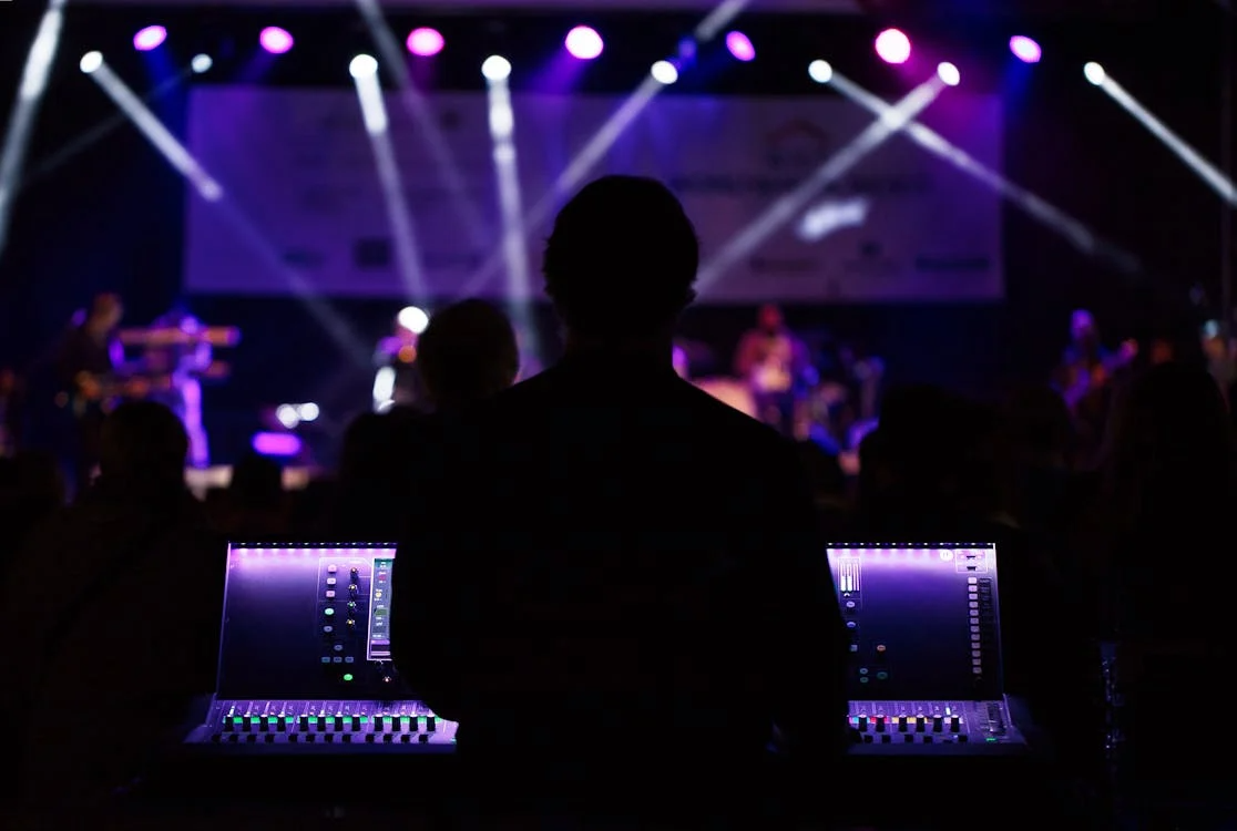 Silhouettes of party guests dancing beside LED screen lighting effects