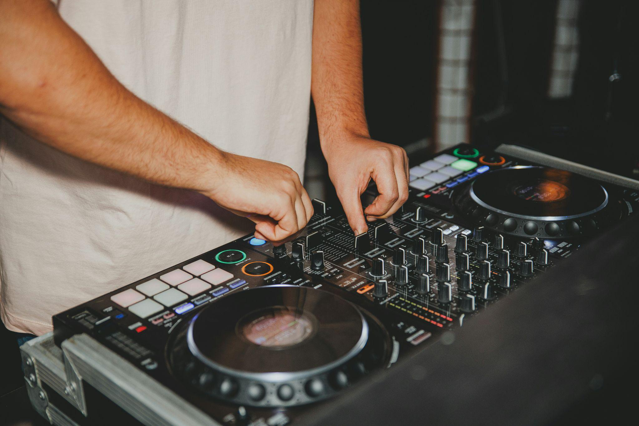 a DJ working on transitions with their equipment