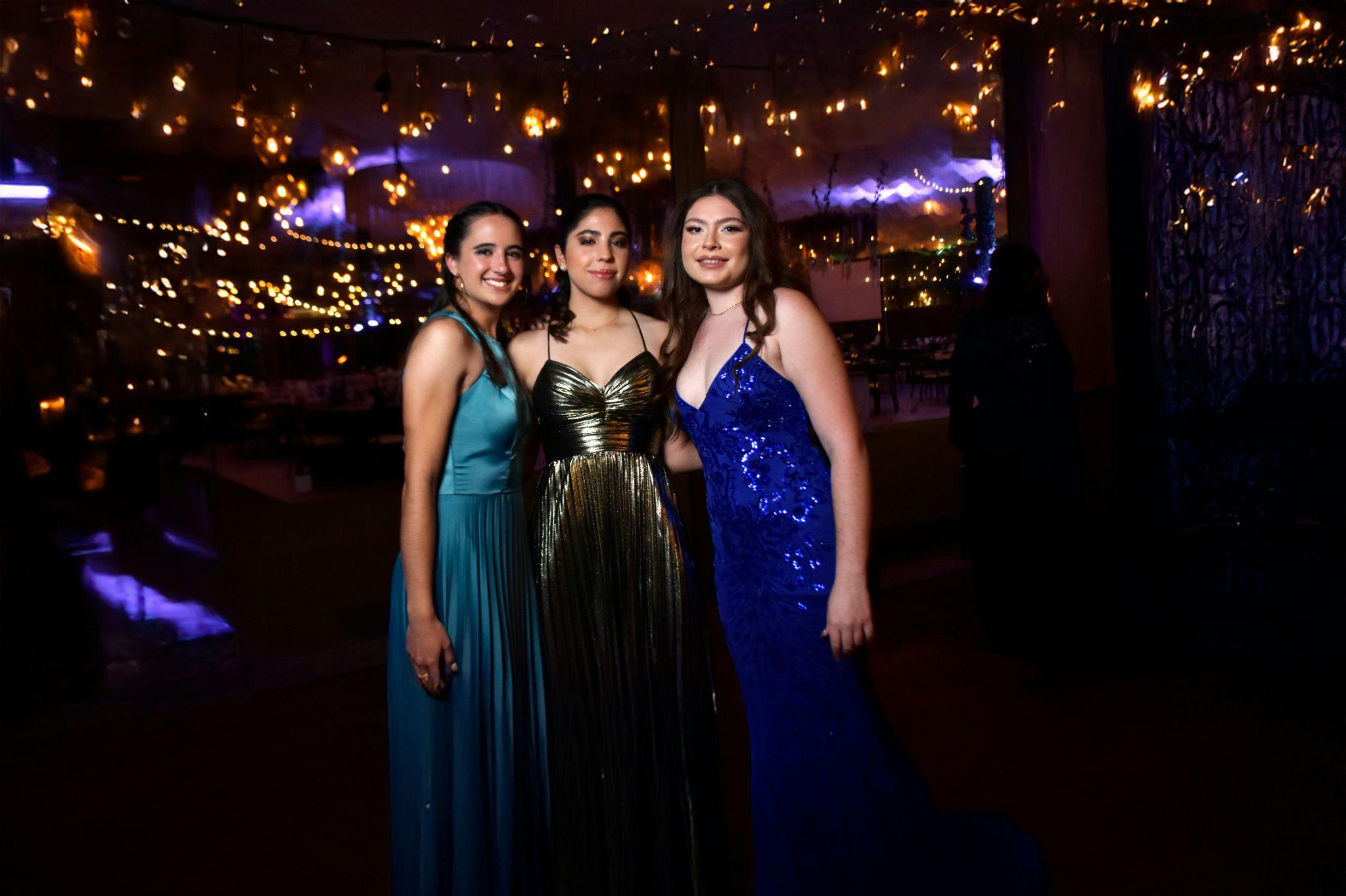 students standing at a decorated prom venue