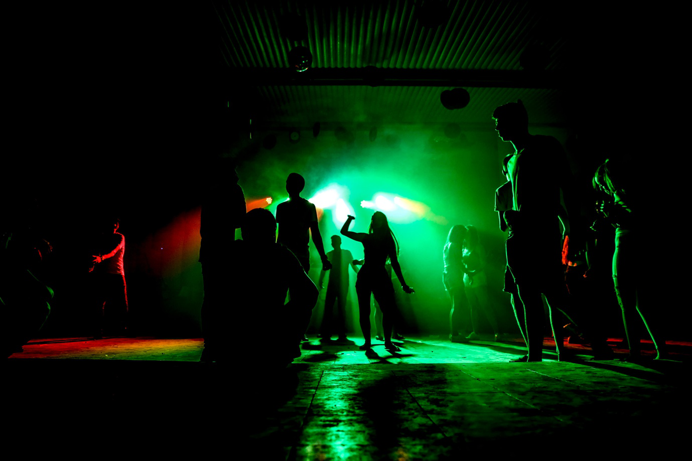 A photo showing silhouettes of people on the dancefloor